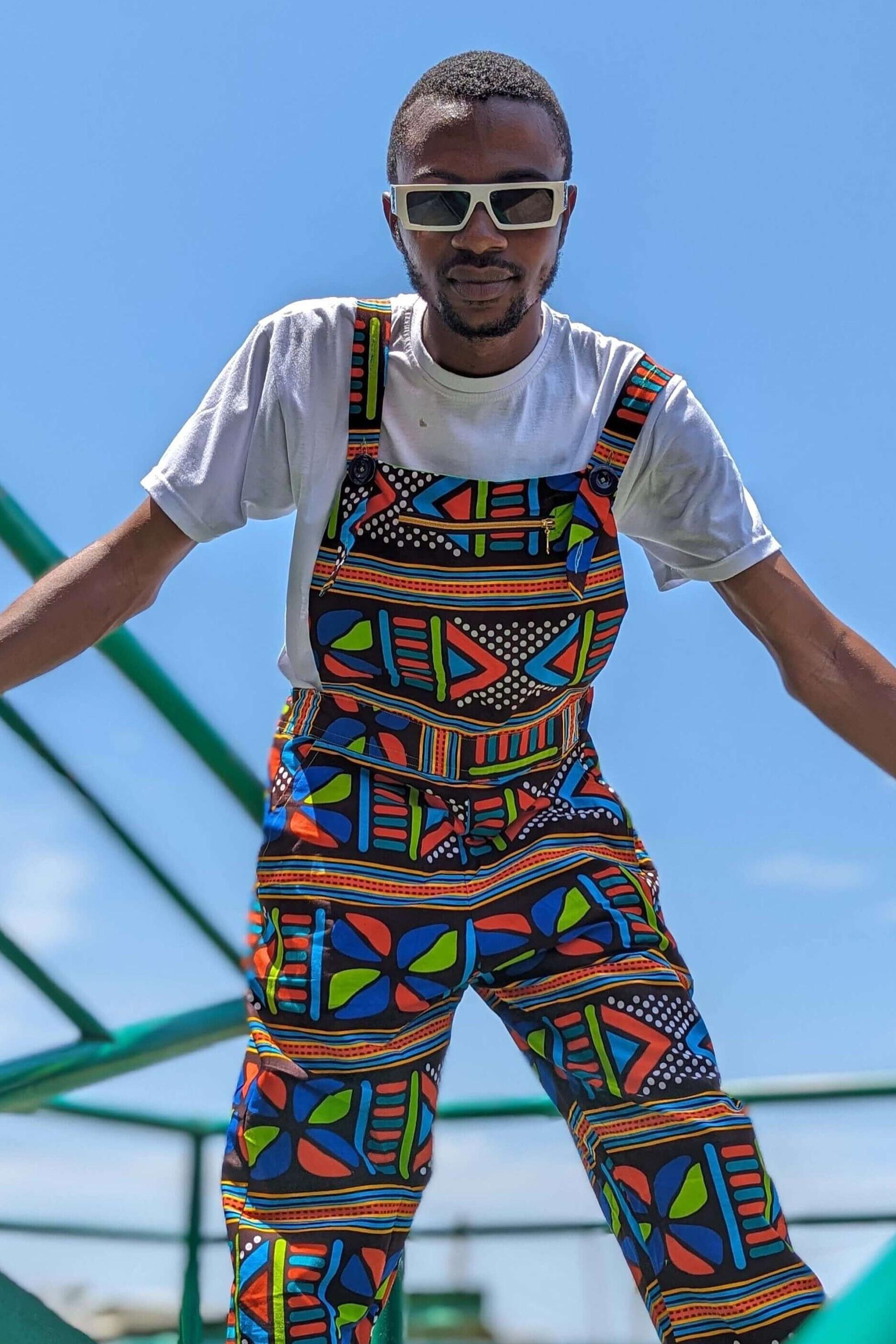 Man wearing African print unisex dungarees