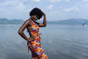 Woman wearing Ashanti Gold kente backless jumpsuit