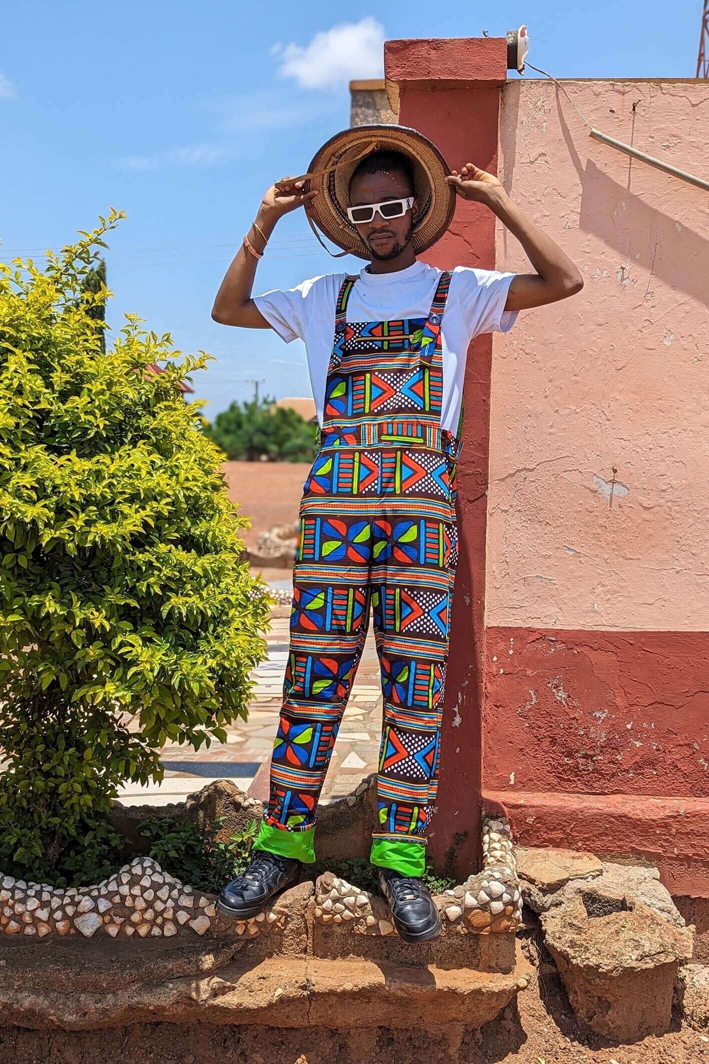 Man wearing African print unisex dungarees