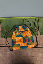 Orange kente print drawstring bag